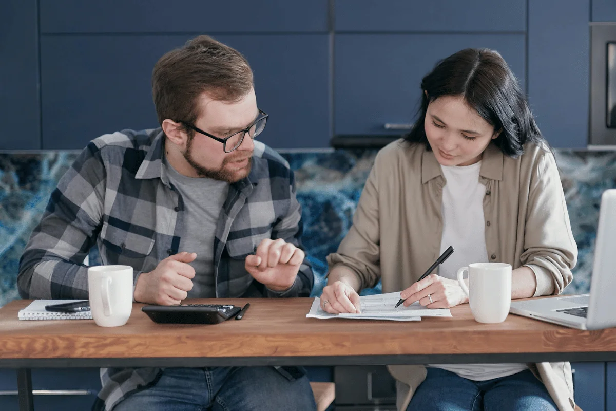 Man and woman discussing household expenses and bills.