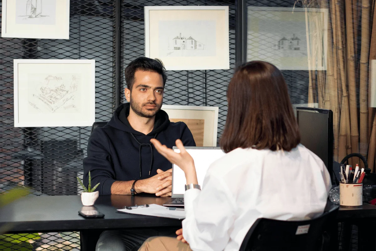 Man and woman discussing business strategy in a contemporary office.