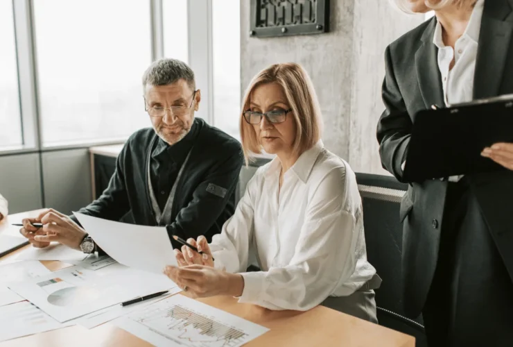 Financial meeting with printed analytics and professional discussion.