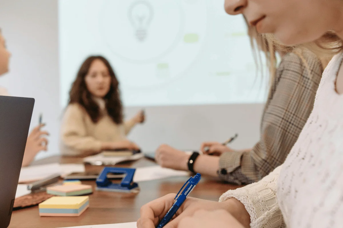 People in a meeting room are focused on a discussion. 