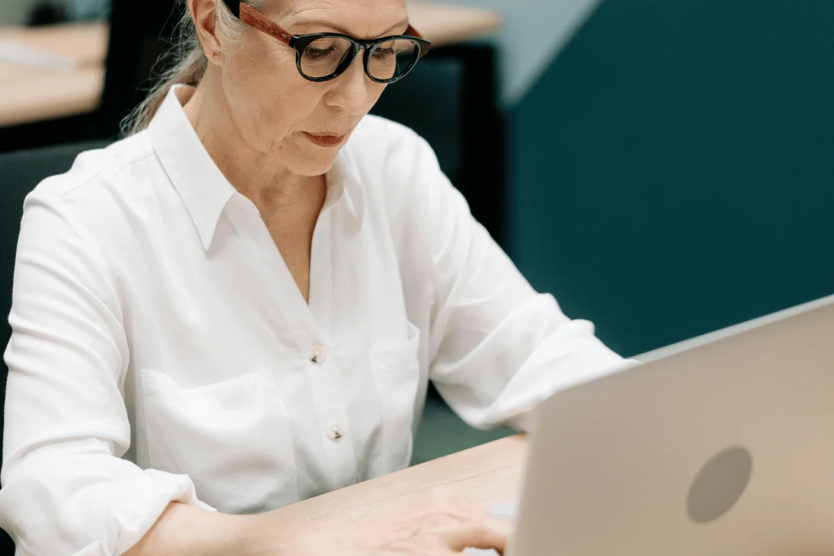 Professional woman typing on her computer during a work session.