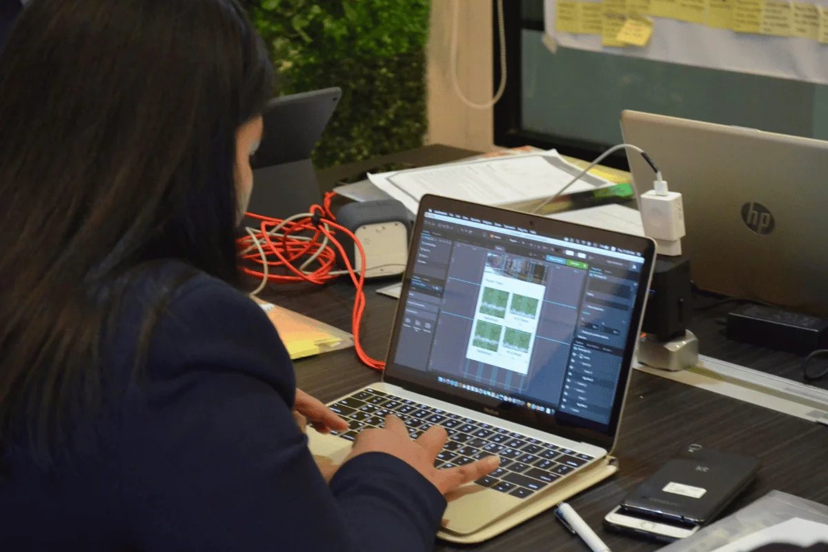 Designer working on a web project using laptop software.