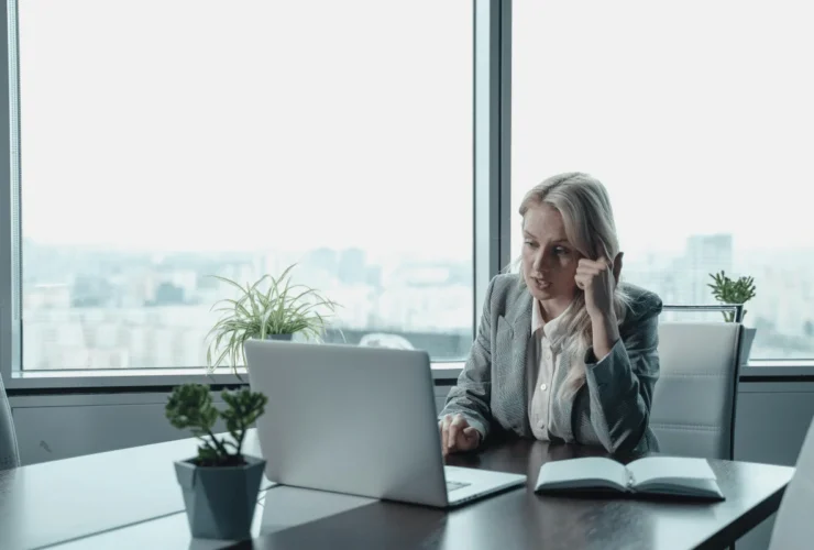 Woman in suit talking during a virtual conference call.