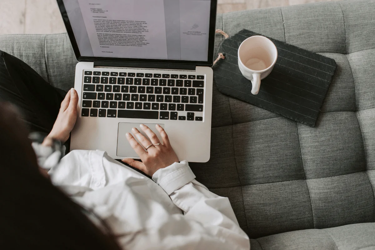 Remote worker drafting a document on a MacBook.