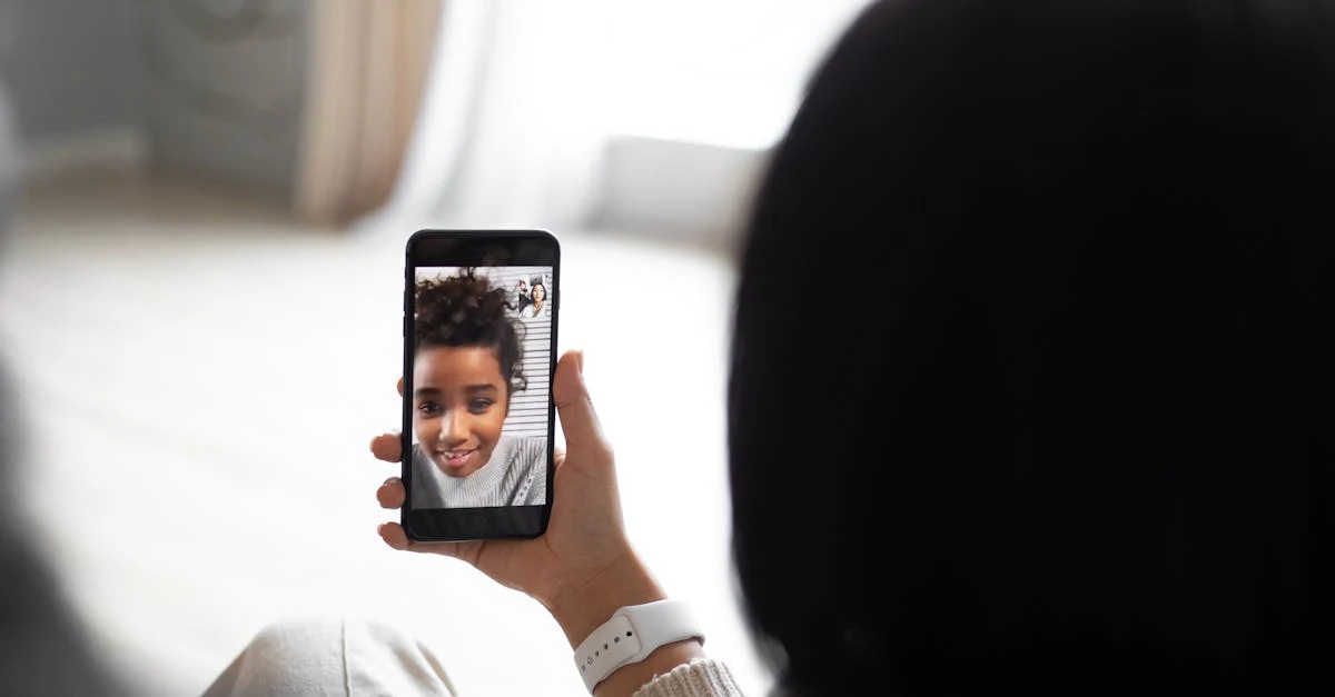 Woman holding smartphone displaying video call with smiling US based executive assistant professional.