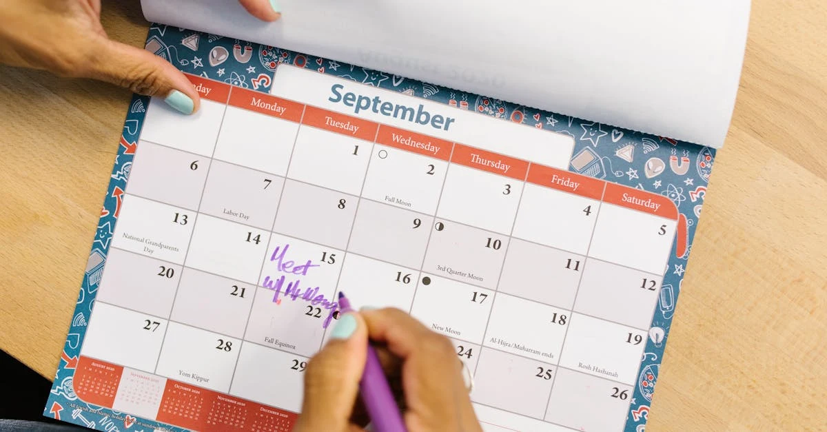Person writing notes on September calendar with purple pen during calendar management virtual assistant planning session.