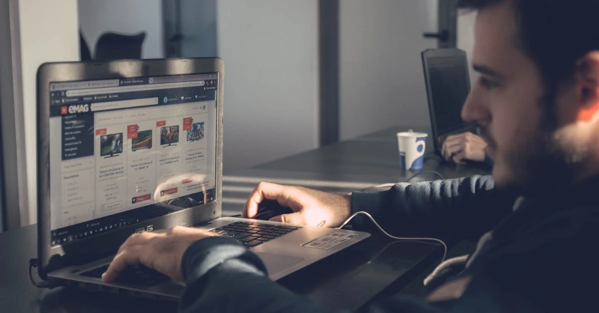 Man reviewing virtual assistant profiles on laptop screen at desk during recruitment search.