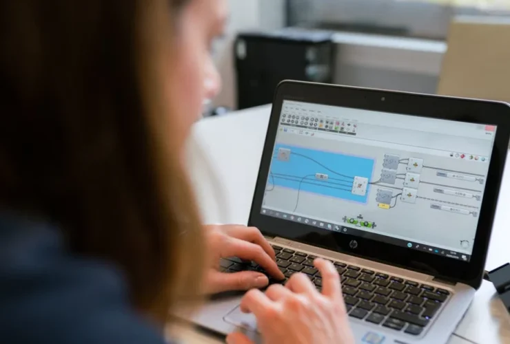 Person viewing Fancy Hands alternatives on laptop screen, evaluating virtual assistant software features and capabilities.